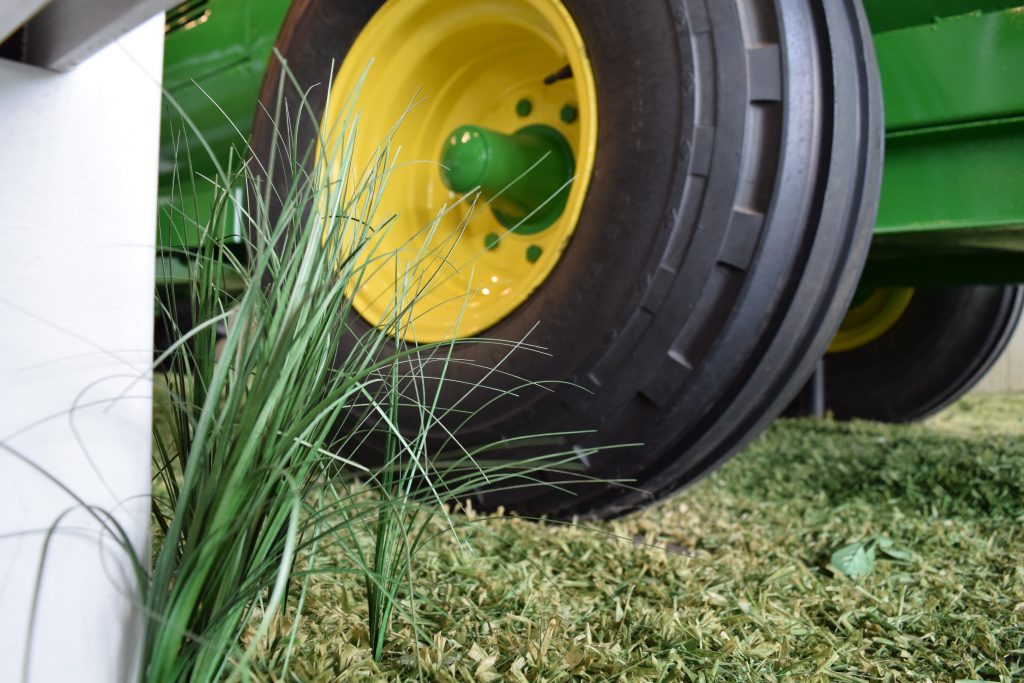 Closeup of a tire and fabricated grass.