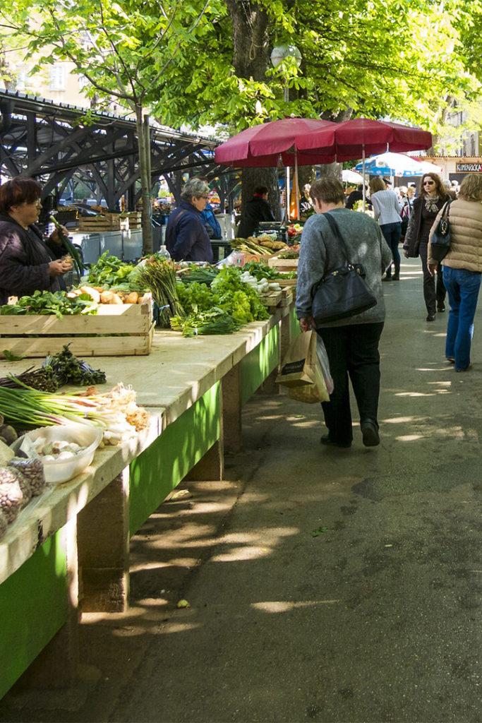 Shoppers and vendors at outdoor farmer's market