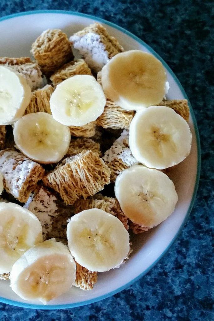 Bowl of frosted wheat cereal and banana slices, used as an example of a fortified food