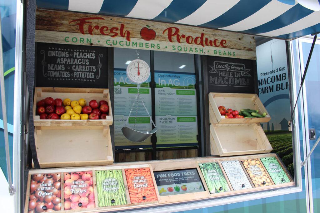 The Fruit vs. Vegetable Display, located in a larger display made to look like a farmers market stand.