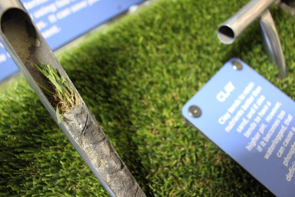 Artificial soil sample pulled out to show artificial soil and grass