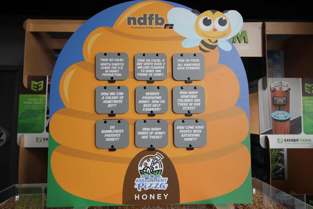Tabletop display about honey sitting in front of other Exhibit Farm displays