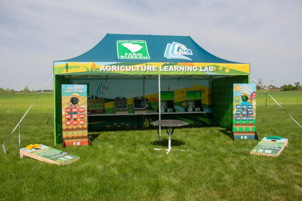 An educational tent filled with displays about agriculture