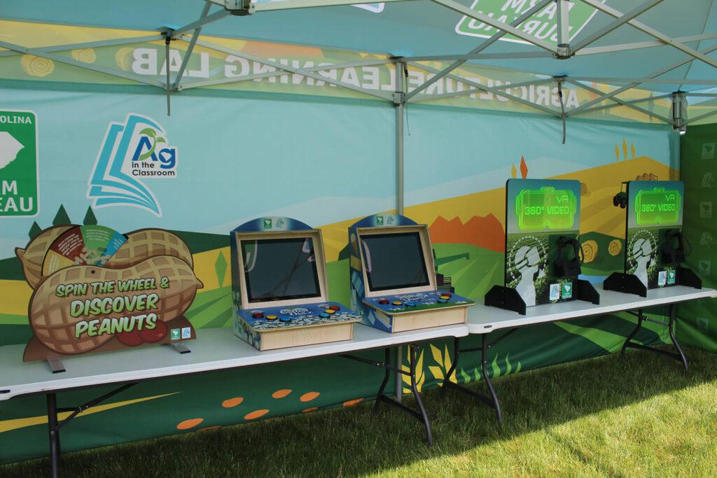 Several displays for agriculture education inside an exhibit tent