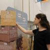 A woman spins one of the boxes on the Misconceptions about Agriculture display