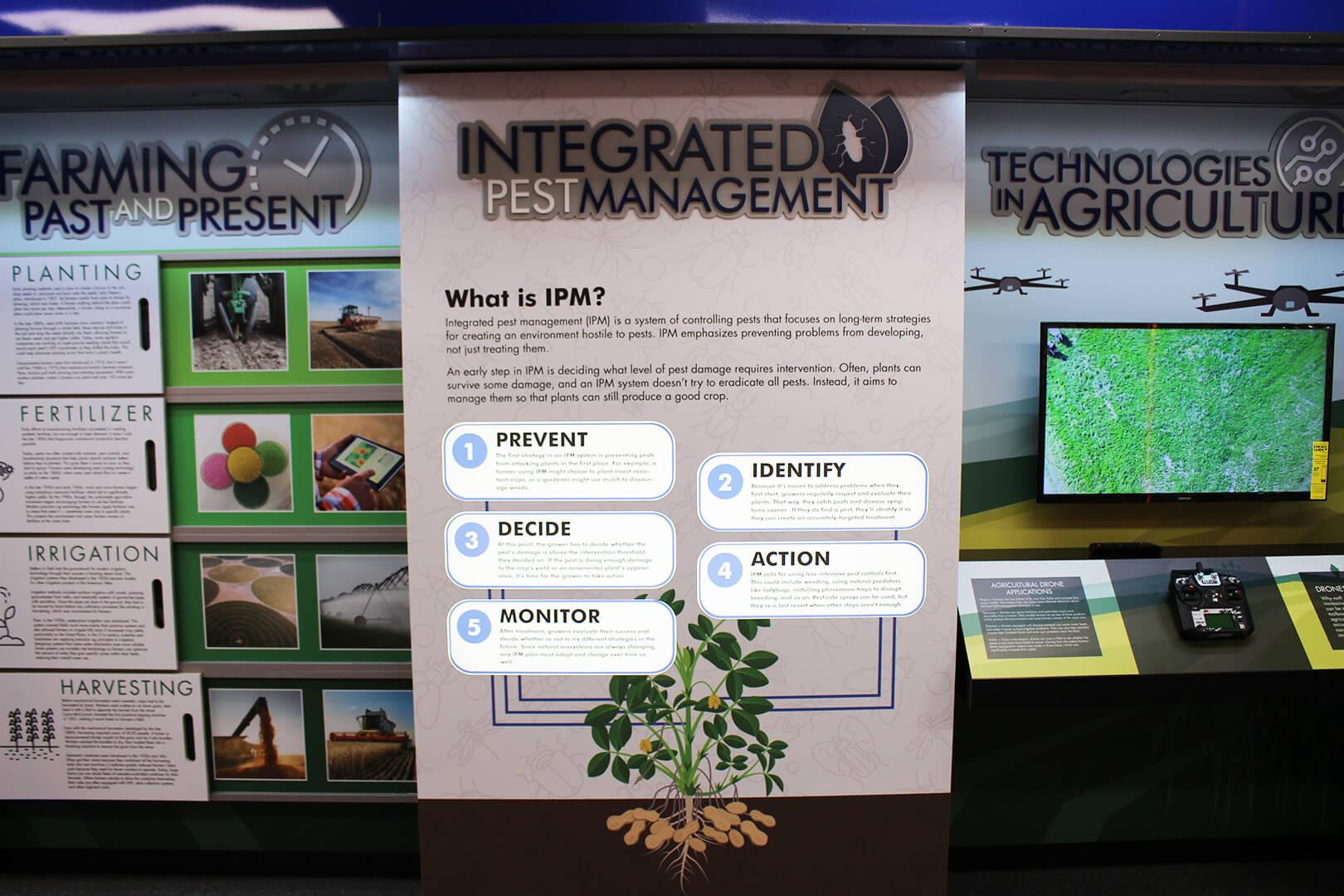 The Integrated Pest Management display flanked by two displays about agricultural technology.