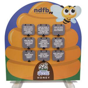 Tombstone-shaped display about honey with graphics of a beehive and cartoon bee.