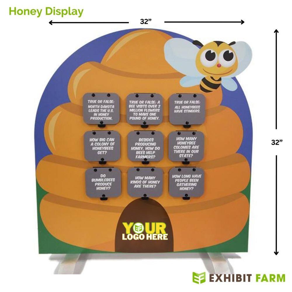 Tombstone-shaped display about honey with graphics of a beehive and cartoon bee.